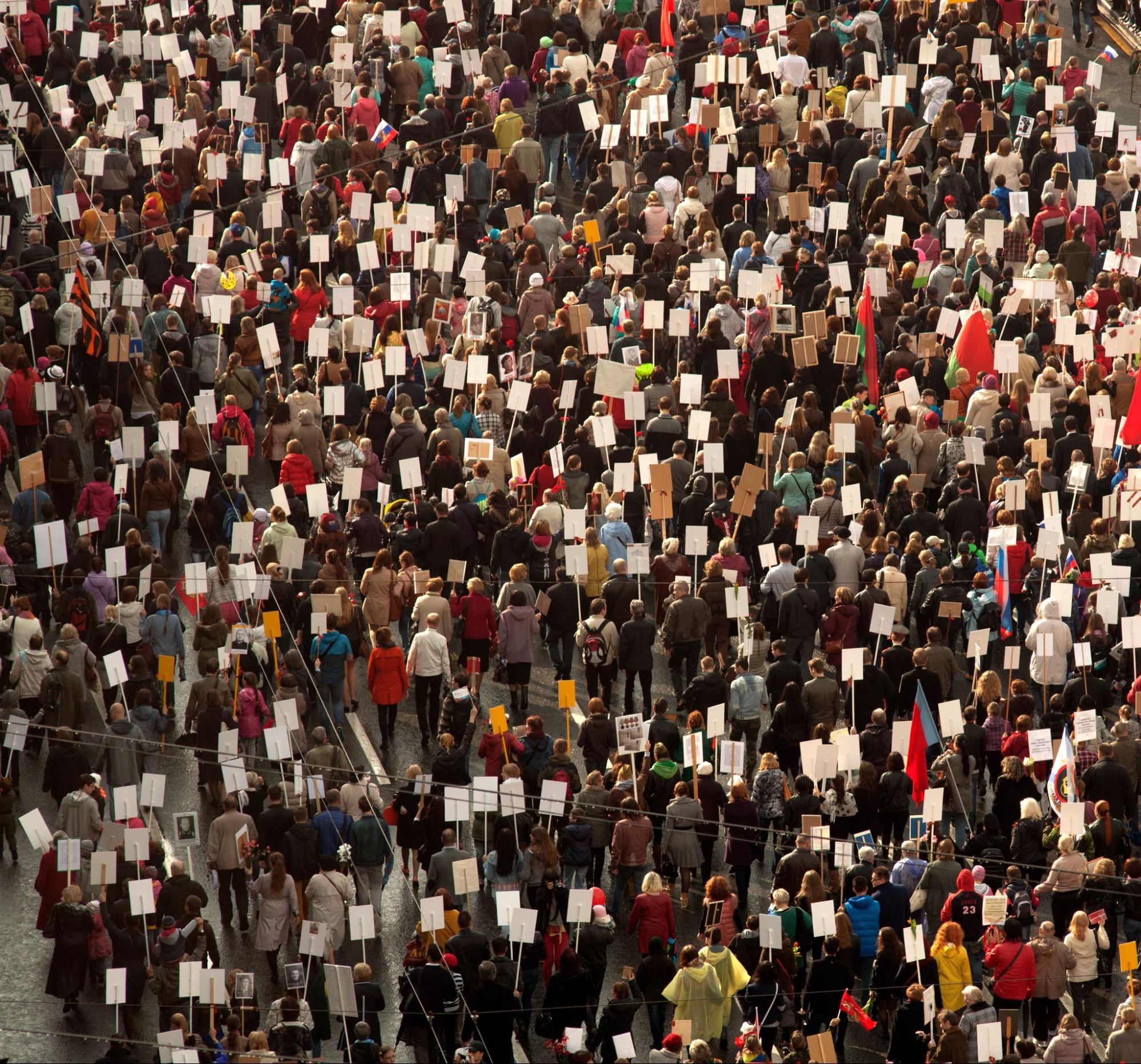 view of crowd at protest holding signs